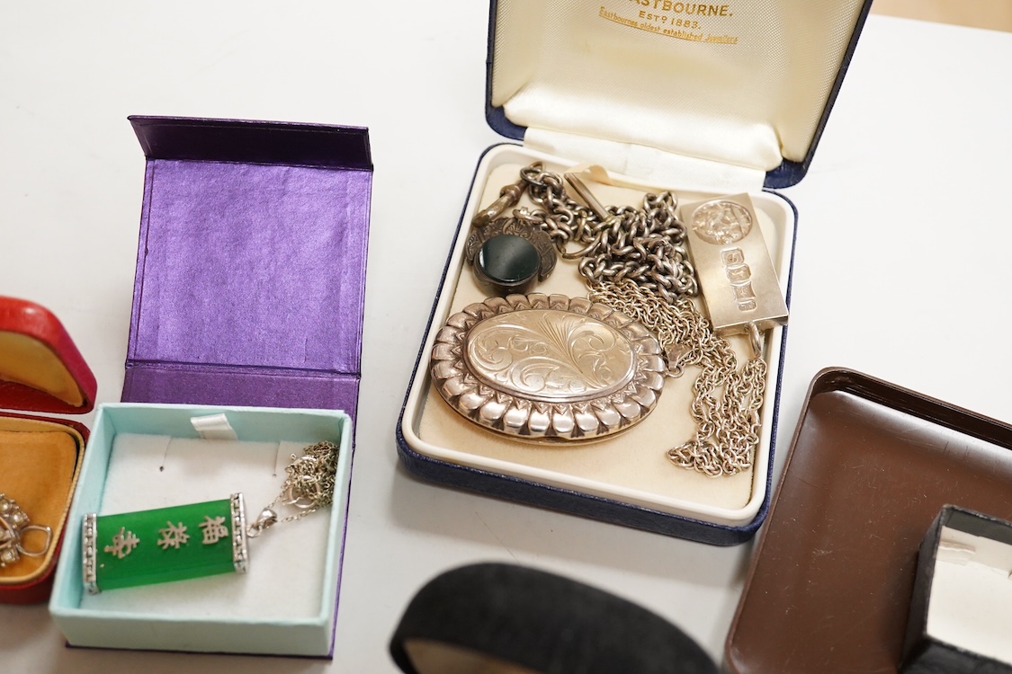 A collection of silver and costume jewellery, including a silver locket, St Christopher ingot pendant and watch chain, and a selection of costume jewels